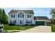 Charming two-story home with green garage door, manicured lawn, and beautiful landscaping at 4243 Bay Leaf Cir, Indianapolis, IN 46237