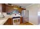 Close up of the kitchen featuring stainless steel appliances, wooden cabinets, and ample counter space at 4243 Bay Leaf Cir, Indianapolis, IN 46237