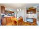 Cozy kitchen nook with wooden cabinets, stainless appliances, and a breakfast table at 4243 Bay Leaf Cir, Indianapolis, IN 46237