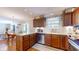 Open-concept kitchen boasting wooden cabinetry, stainless steel appliances, and a seamless transition to the dining area at 4243 Bay Leaf Cir, Indianapolis, IN 46237