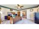 Well-organized home office featuring a large desk, a ceiling fan, and built-in storage solutions at 4243 Bay Leaf Cir, Indianapolis, IN 46237