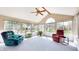 Bright sunroom featuring plenty of natural light and comfortable seating with a ceiling fan at 4243 Bay Leaf Cir, Indianapolis, IN 46237