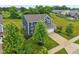 Aerial view of a home with a well-maintained lawn, two-car garage, and surrounded by mature trees at 4245 W Fork Dr, Westfield, IN 46062