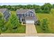 Aerial view of a beautiful two-story home with a well-kept lawn, landscaping, and a two-car garage at 4245 W Fork Dr, Westfield, IN 46062