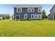 Well-maintained back exterior with a sliding glass door, a small patio, and a spacious yard at 4245 W Fork Dr, Westfield, IN 46062