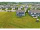 A backyard with a patio, dark blue siding, and an expansive green lawn at 4245 W Fork Dr, Westfield, IN 46062