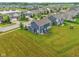 A backyard with a patio, dark blue siding, and an expansive green lawn at 4245 W Fork Dr, Westfield, IN 46062