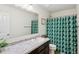 A bathroom featuring a sink, a large mirror, a patterned shower curtain, and a white toilet at 4245 W Fork Dr, Westfield, IN 46062