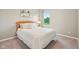 A bright bedroom featuring a cozy bed with white linens and a window that provides a view of a lush landscape at 4245 W Fork Dr, Westfield, IN 46062