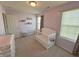 Bright Bedroom with a white crib, changing table, and natural light at 4245 W Fork Dr, Westfield, IN 46062