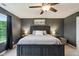 A dark bedroom featuring a large bed, a ceiling fan with lights, and two bedside tables with lamps at 4245 W Fork Dr, Westfield, IN 46062