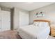 A bright bedroom featuring a bed with white linens and two closet doors and neutral carpet at 4245 W Fork Dr, Westfield, IN 46062