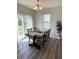 Bright dining room with backyard view, a chandelier, and a black wood dining table for six at 4245 W Fork Dr, Westfield, IN 46062