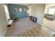 Cozy living room with a rocking chair, neutral carpet, and vinyl flooring leading into another seating area at 4245 W Fork Dr, Westfield, IN 46062