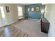 Comfortable living room featuring blue accent wall, neutral carpet, and a rocking chair near the window at 4245 W Fork Dr, Westfield, IN 46062