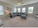 Comfortable living room featuring a large gray sectional sofa, neutral carpet, and lots of natural light at 4245 W Fork Dr, Westfield, IN 46062