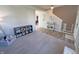 Open living area with vinyl flooring and neutral carpet with a staircase and open view to another room at 4245 W Fork Dr, Westfield, IN 46062