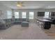 Inviting living room with an open view to the kitchen and a comfortable, oversized gray sectional couch at 4245 W Fork Dr, Westfield, IN 46062