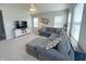 Cozy living room featuring a gray sectional sofa, neutral carpet, and a TV console by the windows at 4245 W Fork Dr, Westfield, IN 46062