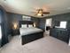 Primary bedroom with a large bed, dark wood furniture, neutral carpet, ceiling fan, and ensuite bathroom at 4245 W Fork Dr, Westfield, IN 46062