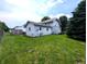 A nice view of a green backyard with the house in the background at 4335 River Rd, Columbus, IN 47203