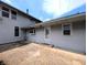A view of the concrete patio of a light colored house, showing the back door to the home at 4335 River Rd, Columbus, IN 47203