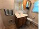 Tiled bathroom featuring a vanity with storage, a toilet, and a window at 4335 River Rd, Columbus, IN 47203
