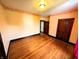 Bright bedroom featuring wood floors, natural light, and multiple entry doors at 4335 River Rd, Columbus, IN 47203