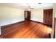 Bright bedroom featuring hardwood floors, a ceiling fan, and a closet at 4335 River Rd, Columbus, IN 47203