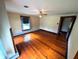 Bright bedroom features gleaming hardwood floors and a large window that fills the room with natural light at 4335 River Rd, Columbus, IN 47203