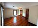 A bright bedroom showcasing gleaming hardwood floors, a ceiling fan, two windows and two doors at 4335 River Rd, Columbus, IN 47203