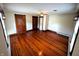 Spacious bedroom featuring beautiful hardwood floors, a ceiling fan, and two large windows at 4335 River Rd, Columbus, IN 47203