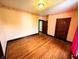 Spacious bedroom featuring wood floors, natural light, and two entry doors at 4335 River Rd, Columbus, IN 47203