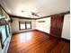 Bedroom featuring hardwood floors, ceiling fan, decorative wall paper and large windows at 4335 River Rd, Columbus, IN 47203