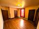 Bedroom with hardwood floors, natural light from window, and entry doors at 4335 River Rd, Columbus, IN 47203