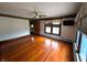 Bedroom featuring gleaming hardwood floors, a ceiling fan, and natural light from window at 4335 River Rd, Columbus, IN 47203
