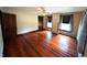 Bedroom featuring gleaming hardwood floors, ceiling fan, and three windows offering plenty of natural light at 4335 River Rd, Columbus, IN 47203