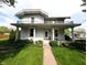 Inviting two-story home featuring a covered front porch and a well-maintained lawn, ideal for Gathering living at 4335 River Rd, Columbus, IN 47203