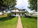 Inviting two-story home with a lovely front porch and manicured lawn, creating a warm and welcoming curb appeal at 4335 River Rd, Columbus, IN 47203