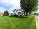 Beautiful home with lush green lawn, showcasing mature trees and a well-kept landscape for peaceful living at 4335 River Rd, Columbus, IN 47203