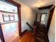 Hallway featuring hardwood floors, rug runner and wood trim at 4335 River Rd, Columbus, IN 47203