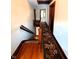 Hallway featuring hardwood floors, rug runner and wood trim at 4335 River Rd, Columbus, IN 47203