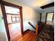 Hallway featuring hardwood floors, rug runner and wood trim at 4335 River Rd, Columbus, IN 47203