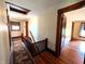 Upstairs hallway with hardwood floors, stairs with wooden railing, and an area rug at 4335 River Rd, Columbus, IN 47203