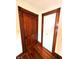 Hallway featuring a solid wood door and closet door, hardwood flooring and decorative trim at 4335 River Rd, Columbus, IN 47203