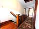 Hallway featuring hardwood floors, rug runner and wood trim at 4335 River Rd, Columbus, IN 47203