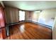Sunlit living room features hardwood floors and a modern air conditioning unit for added comfort at 4335 River Rd, Columbus, IN 47203