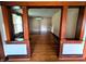Open living room with hardwood floors and decorative woodwork, offering an inviting and spacious atmosphere at 4335 River Rd, Columbus, IN 47203
