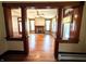 Charming living room with decorative wood columns, hardwood floors, and a cozy fireplace for a warm and inviting atmosphere at 4335 River Rd, Columbus, IN 47203