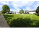 Lush green lawn with scattered trees in a quiet neighborhood, offering a peaceful and spacious environment at 4335 River Rd, Columbus, IN 47203